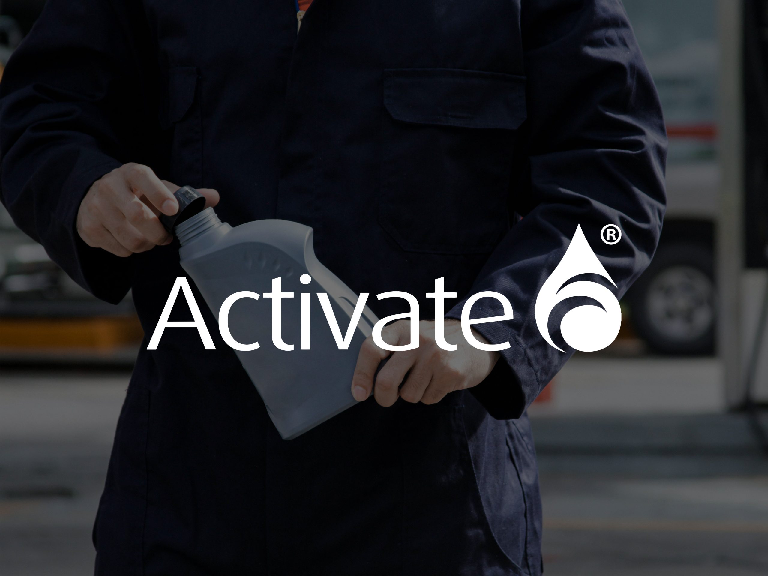 A man holding a large grey bottle with the logo Activate displayed on top