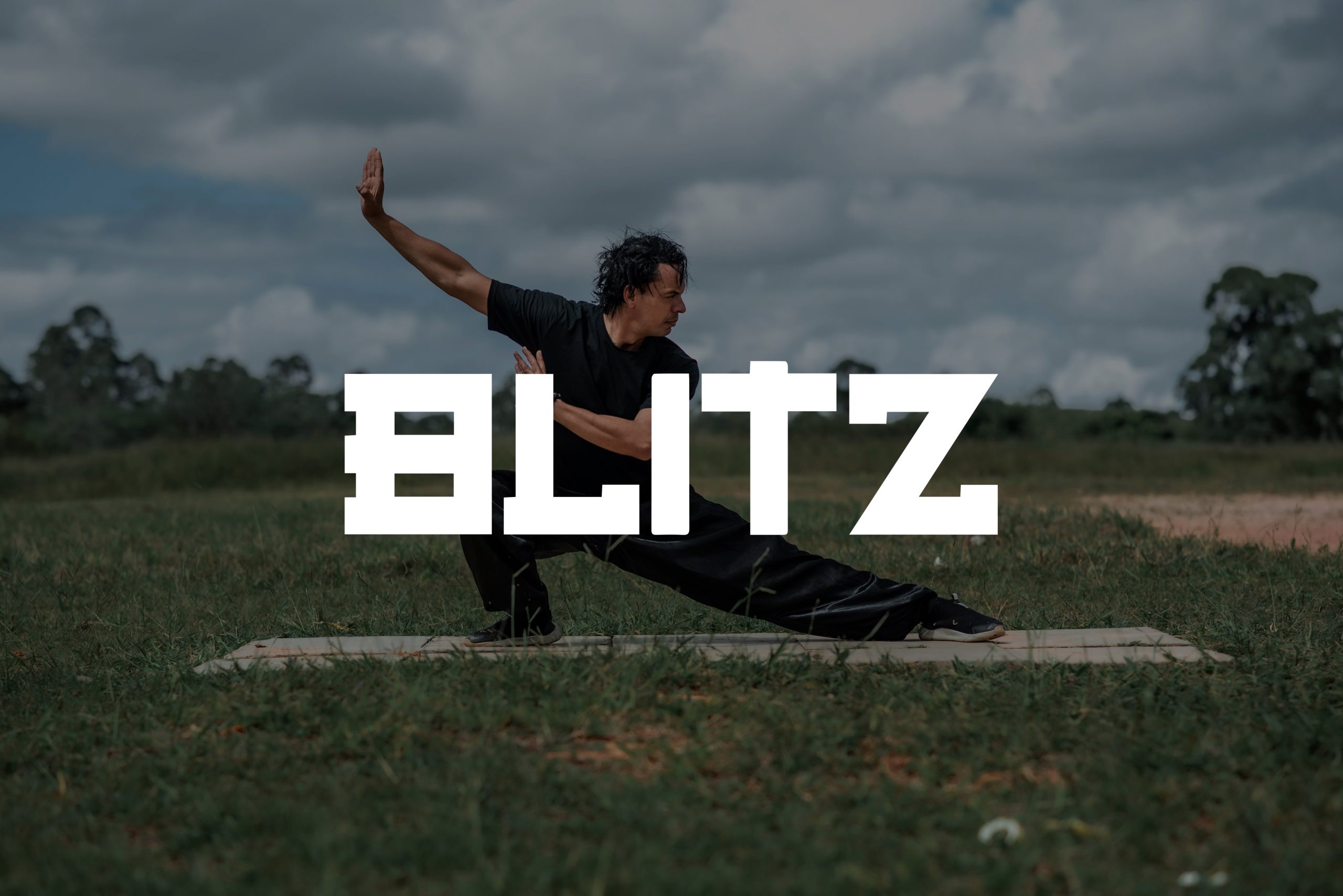 A man practicing martial arts in an outdoor area with the logo BLITZ displayed on top