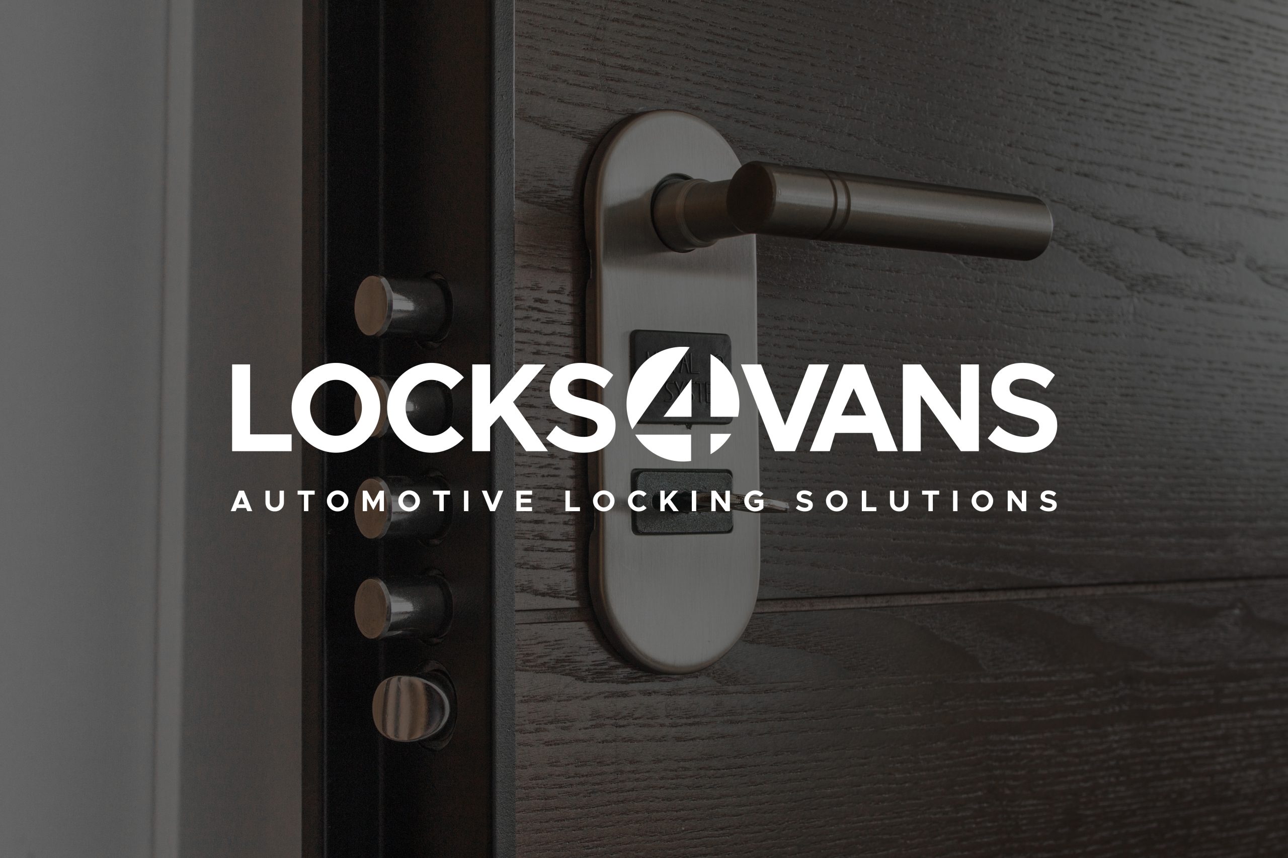 A close up of a door handle and locking mechanism on a dark oak door with the Locks 4 Vans logo displayed on top